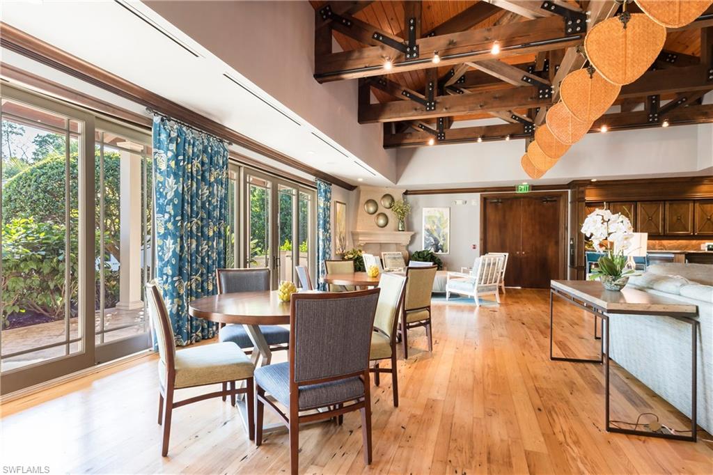 455 Cove Tower Drive, Unit 1101 Naples, FL 34110 - Photo 43 of 49 a dining room with furniture window and wooden floor