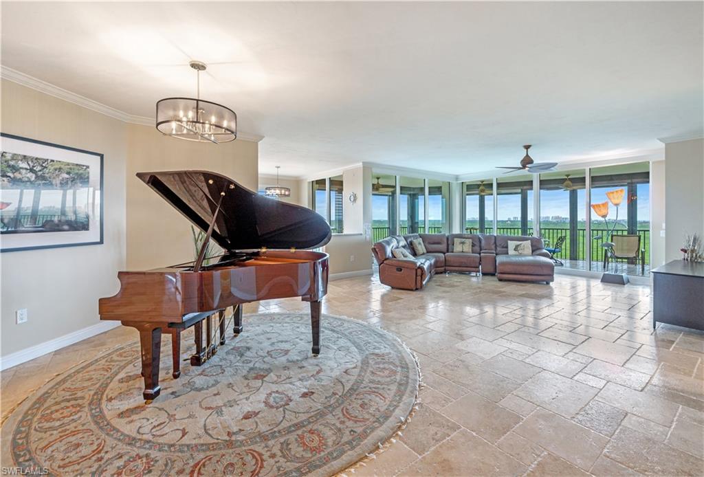 455 Cove Tower Drive, Unit 1101 Naples, FL 34110 - Photo 5 of 49 a living room with furniture chess table and a large window