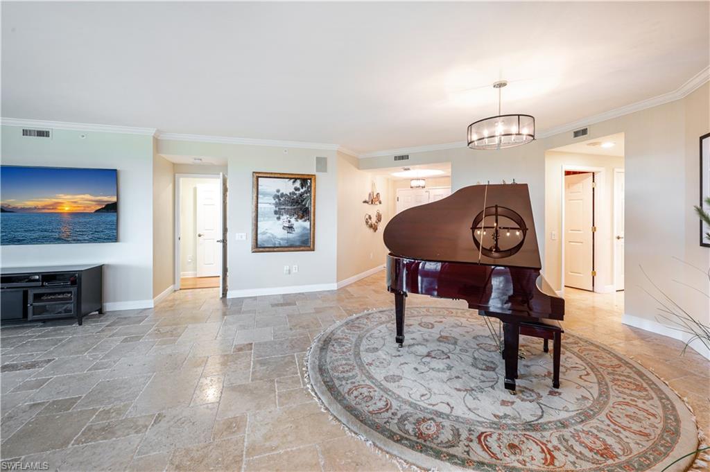 455 Cove Tower Drive, Unit 1101 Naples, FL 34110 - Photo 9 of 49 a living room with furniture and a flat screen tv