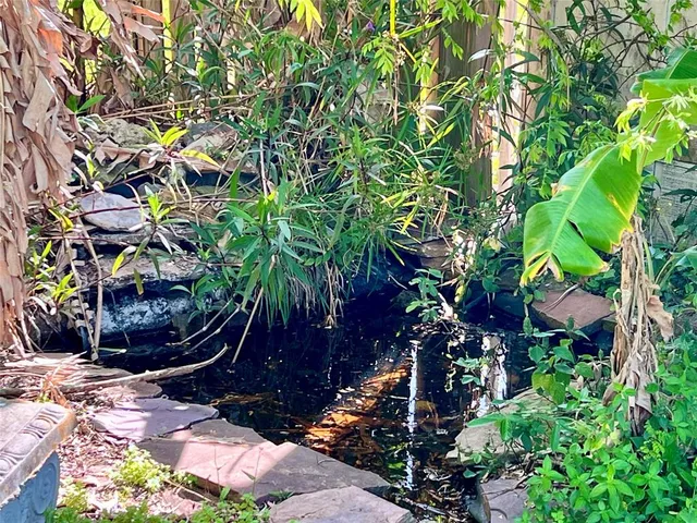 a view of a kitchen with a sink and microwave