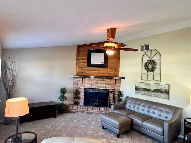 a living room with furniture a window and a fireplace