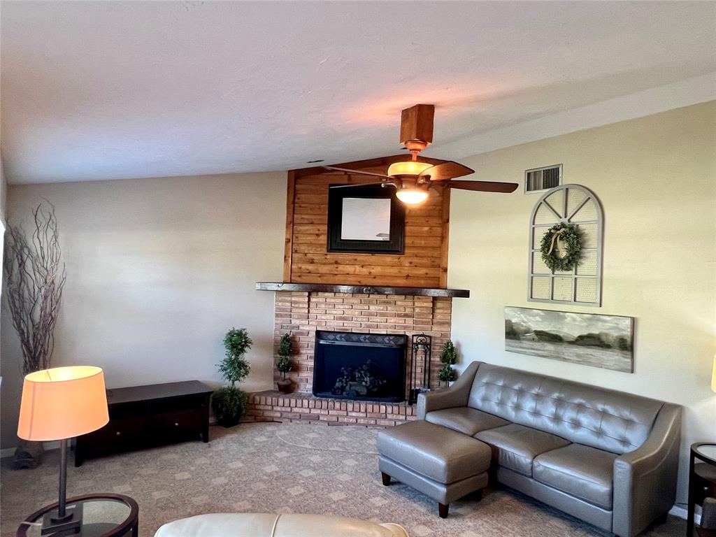 352 Southwest 85th Avenue Okeechobee, FL 34974 - Photo 12 of 21 a living room with furniture and a fireplace
