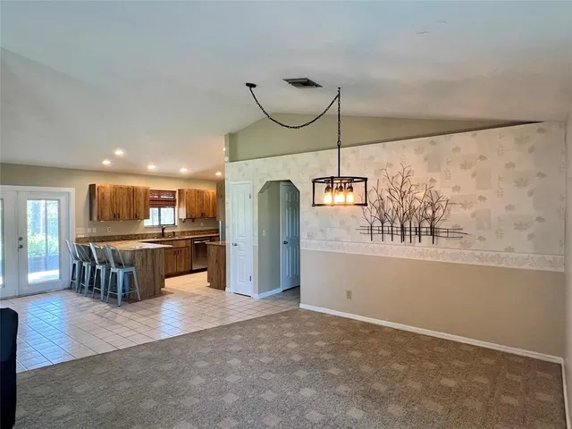 a kitchen with kitchen island granite countertop lots of counter top space and stainless steel appliances