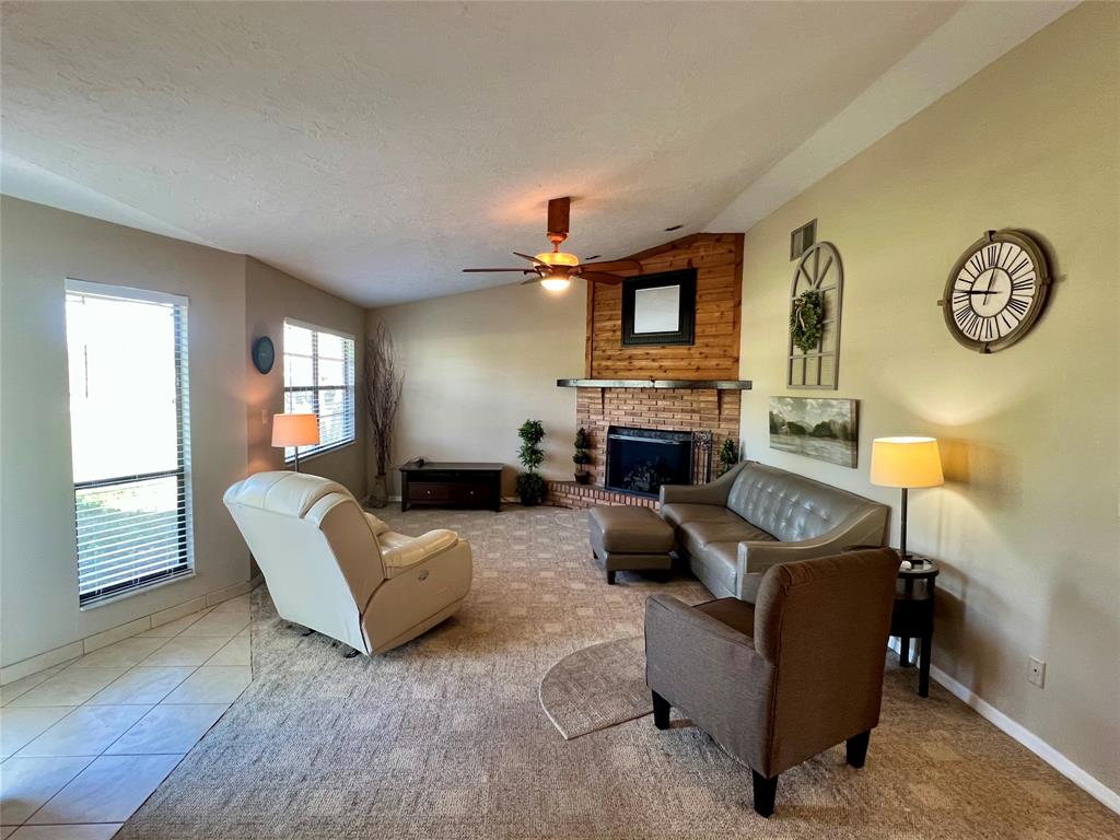 352 Southwest 85th Avenue Okeechobee, FL 34974 - Photo 14 of 21 a living room with furniture a window and a fireplace