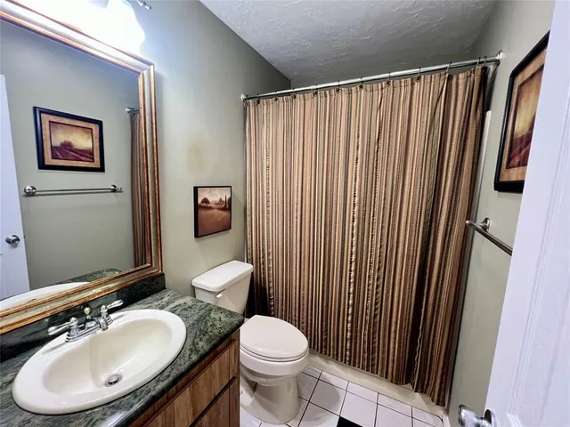 a view of a room with a window and a fan