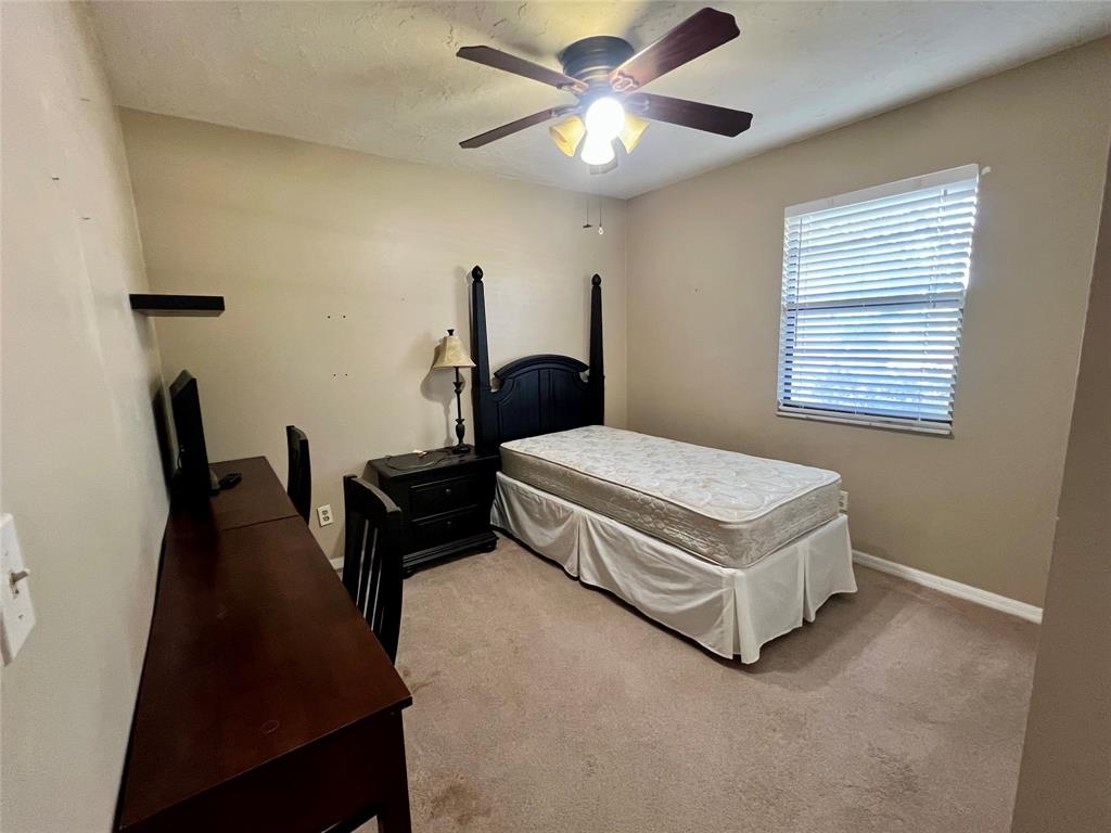 352 Southwest 85th Avenue Okeechobee, FL 34974 - Photo 17 of 21 a bedroom with a bed and a chandelier