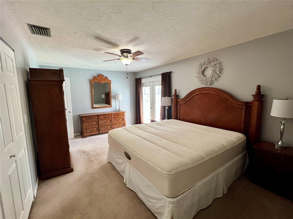 352 Southwest 85th Avenue Okeechobee, FL 34974 - Photo 19 of 21 a bedroom with a large bed and a chandelier