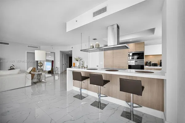 a kitchen with stainless steel appliances granite countertop a sink and a refrigerator