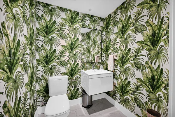 a spacious bedroom with a bed a large window and flat screen tv