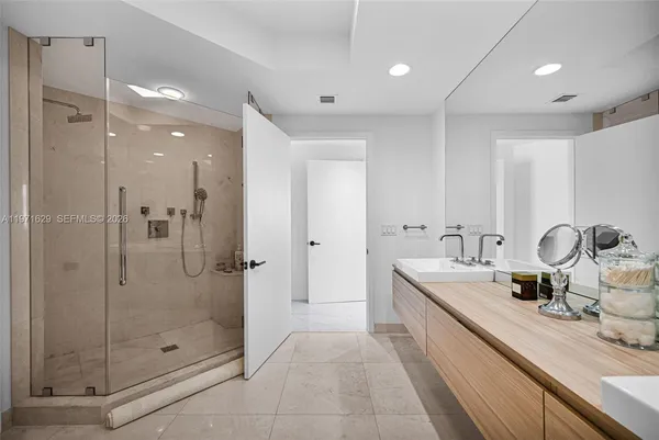 a spacious bathroom with a double vanity sink and a bathtub