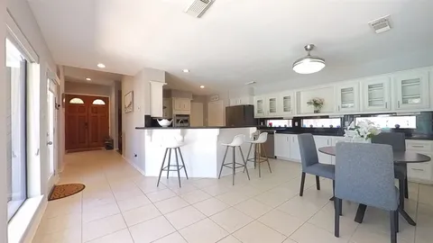 a living room with stainless steel appliances kitchen island granite countertop furniture and a view of kitchen
