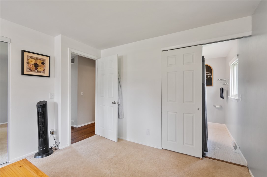 218 Kusak Road Henrietta, NY 14467 - Photo 11 of 33 Primary bedroom with door open to primary bathroom