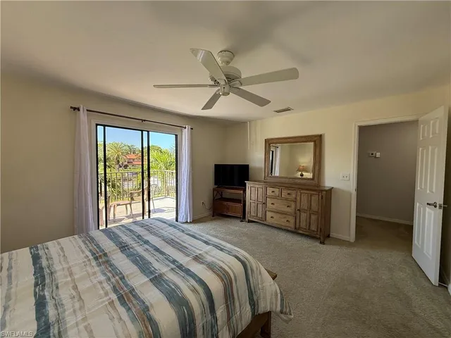 a bedroom with a large bed and a tv