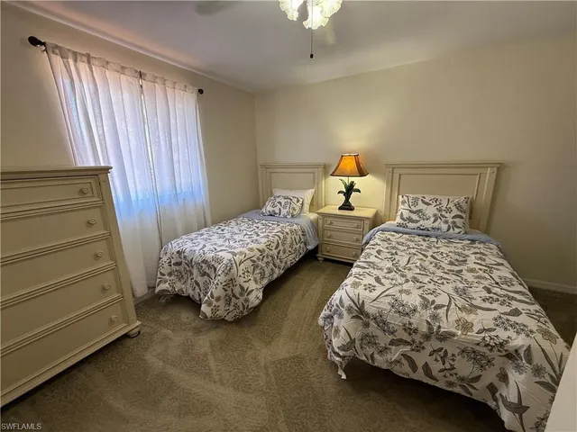 a bedroom with two beds and a window