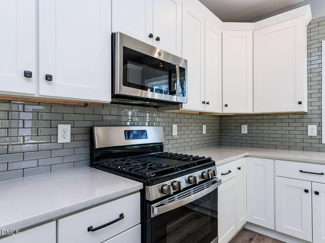 a bathroom with a sink toilet vanity and tub