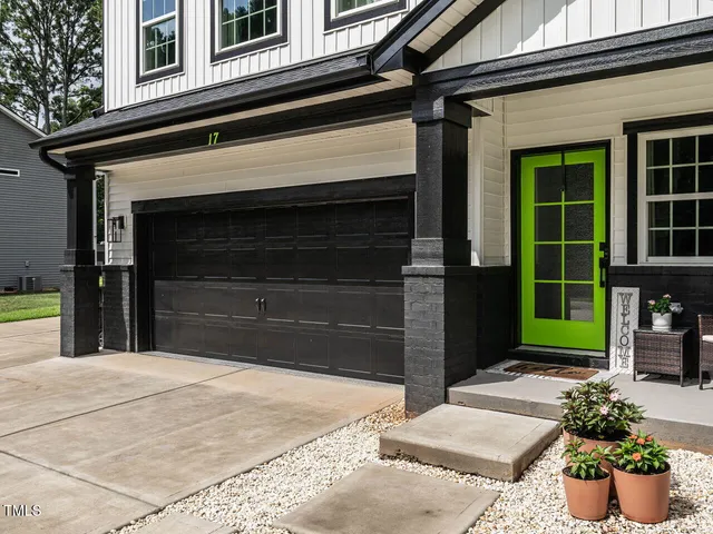 an empty room with wooden floor and ceiling fan