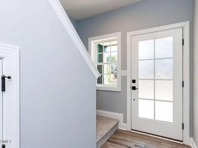 a kitchen with cabinets appliances a sink and a window