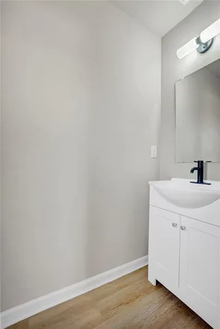 a room with a sink and a mirror