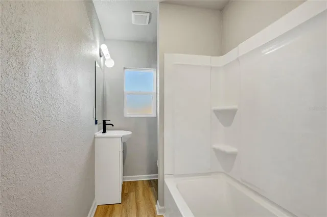 a bathroom with a bathtub and a shower