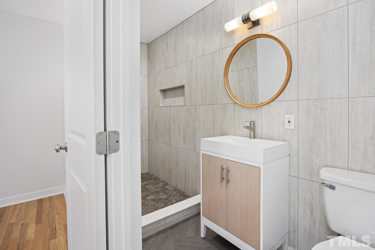 500 Doby Circle Raleigh, NC 27610 - Photo 16 of 40 a bathroom with a sink a toilet and a mirror