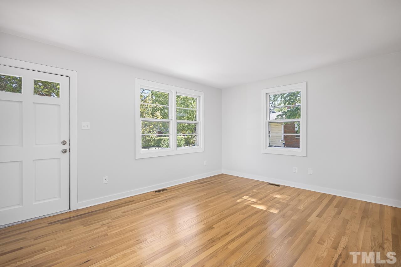 500 Doby Circle Raleigh, NC 27610 - Photo 5 of 40 a view of an empty room with wooden floor and a window
