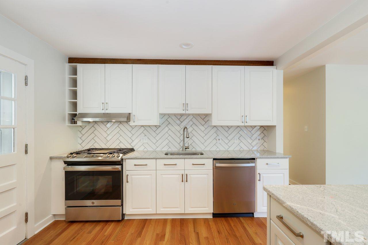 500 Doby Circle Raleigh, NC 27610 - Photo 8 of 40 a kitchen with granite countertop white cabinets and white appliances