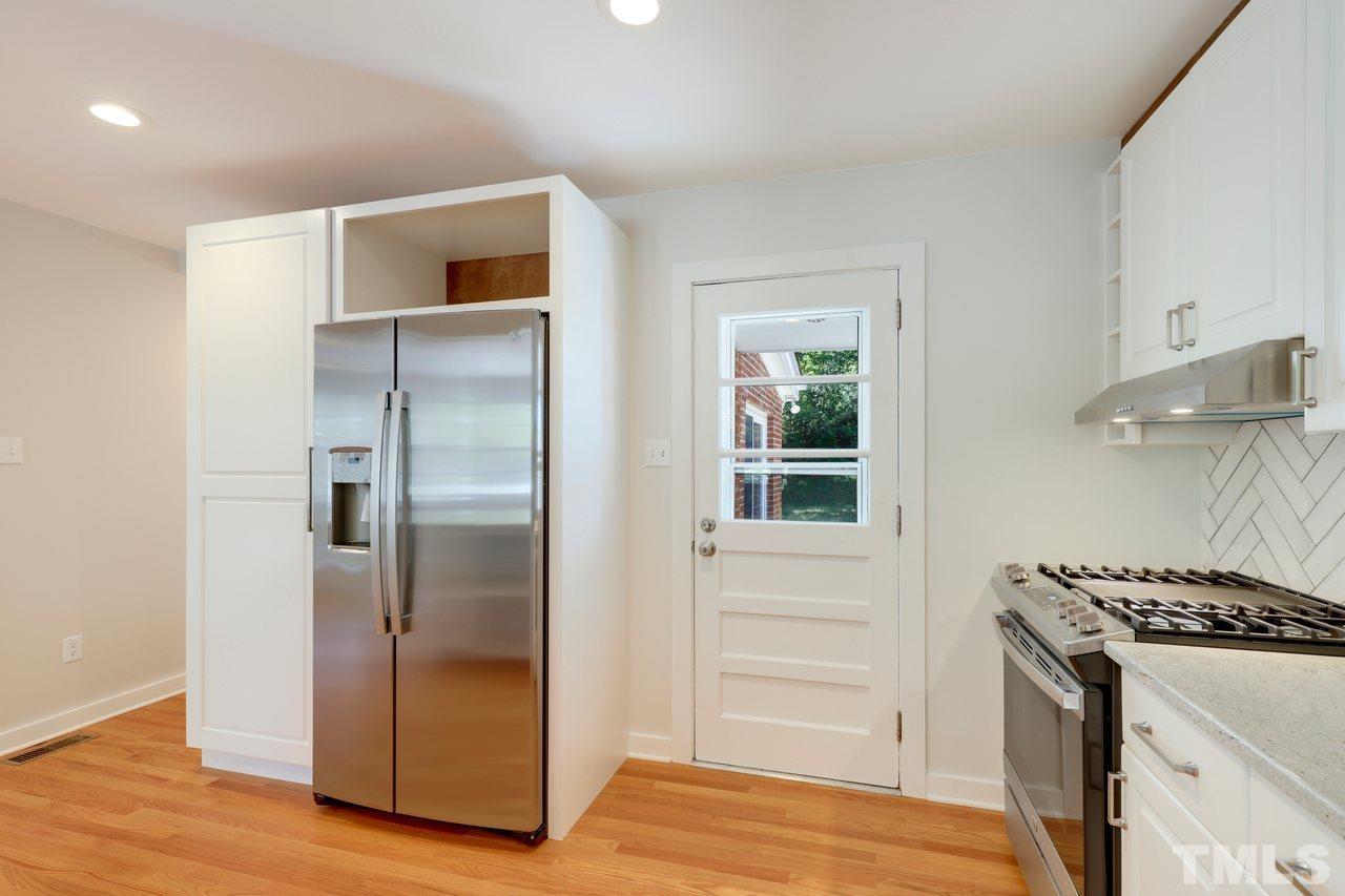 500 Doby Circle Raleigh, NC 27610 - Photo 10 of 40 a kitchen with a refrigerator and a stove top oven