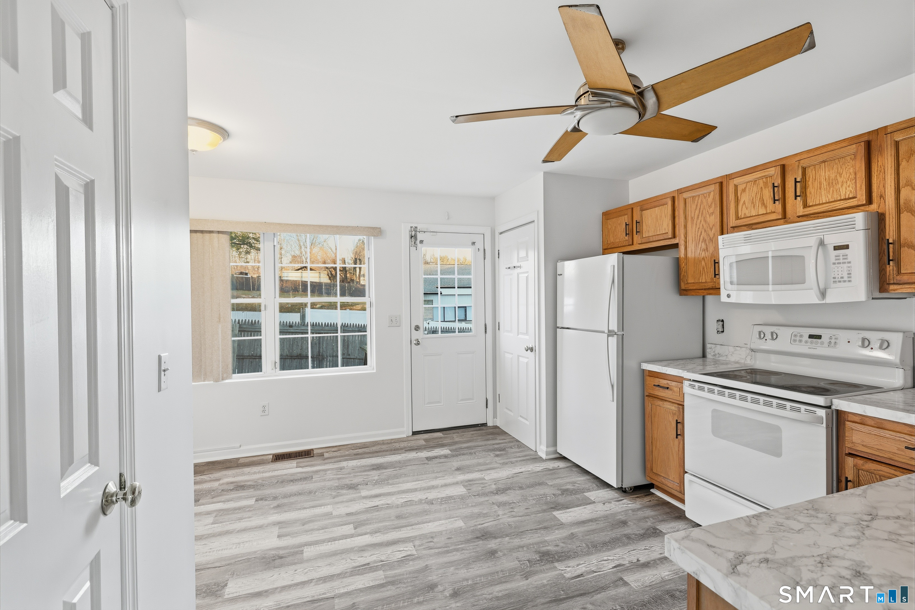 135 Bucks Hill Road, Unit 10 Waterbury, CT 06704 - Photo 3 of 20 a view of a kitchen with a stove cabinets and wooden floor