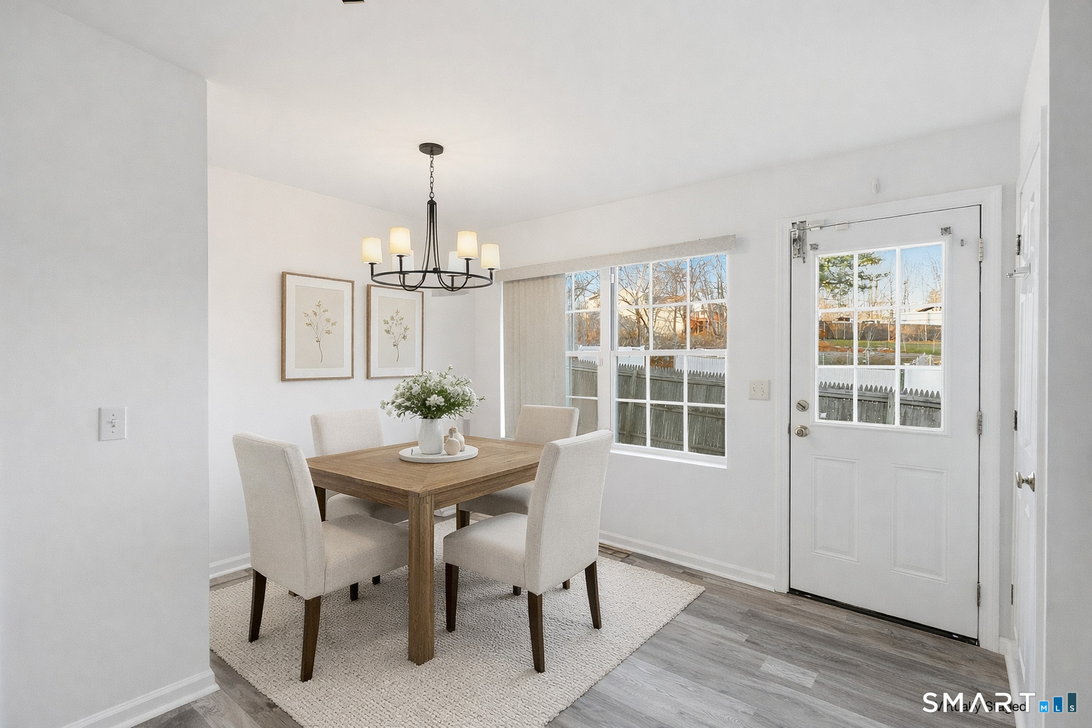 135 Bucks Hill Road, Unit 10 Waterbury, CT 06704 - Photo 4 of 20 a dining room with furniture a chandelier and wooden floor