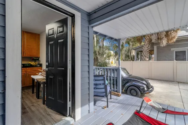 a view of front door and porch with furniture
