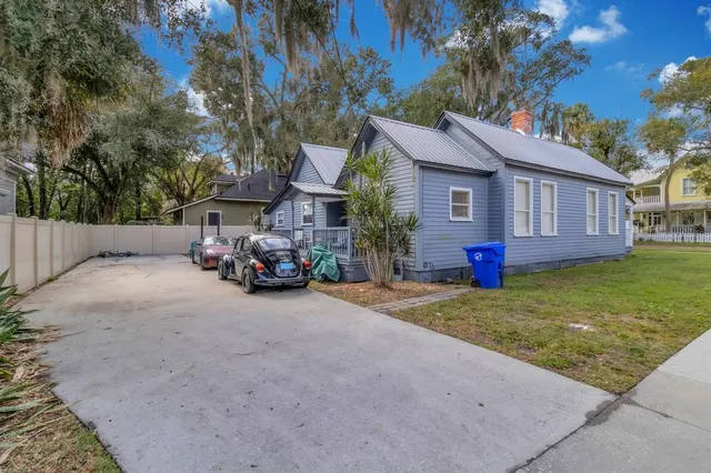 a view of a house with a yard and garage