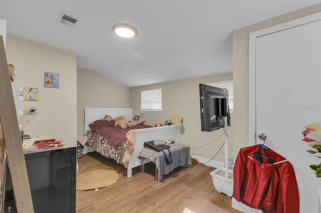 a bedroom with a bed and a couch