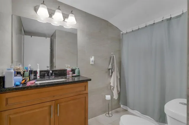 a bathroom with a double vanity sink mirror and toilet