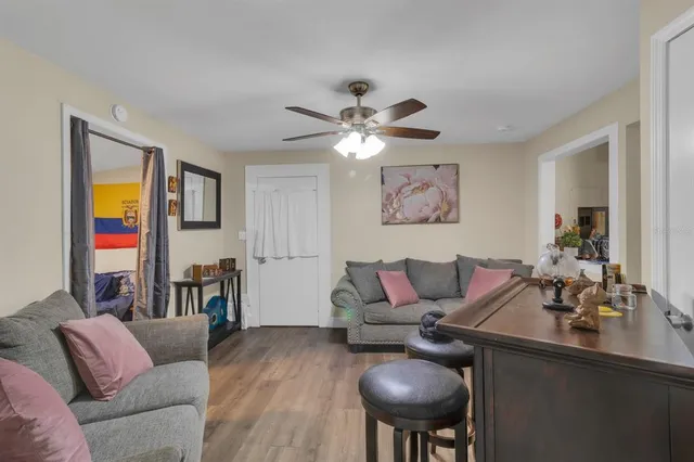 a living room with furniture and a chandelier