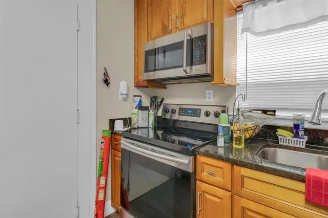 a kitchen with stainless steel appliances a stove a sink and a microwave