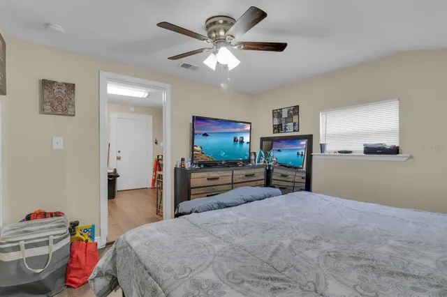 a bedroom with a bed and a flat screen tv