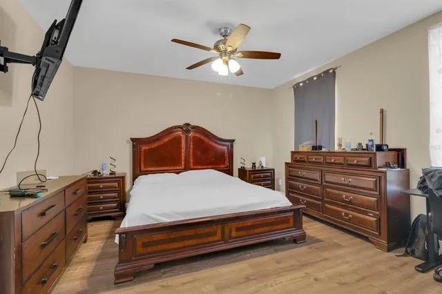 a bedroom with a bed and a chandelier