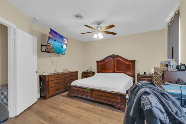 a bedroom with a bed and a chandelier