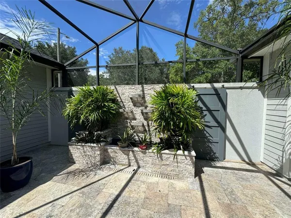 a view of a porch with a table and chairs and potted plants