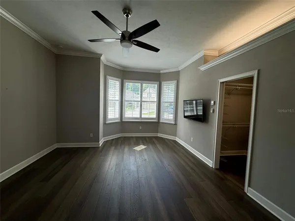 a view of walk in closet with empty racks