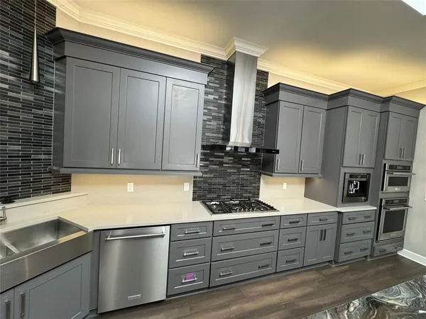 a kitchen with a table chairs and wooden floor
