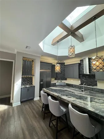 a view of a livingroom with hardwood floor and a ceiling fan
