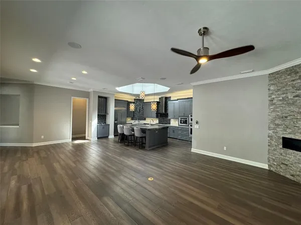 a living room with furniture and a ceiling fan