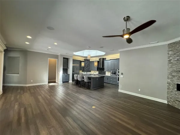 a view of a porch with wooden floor and a fireplace
