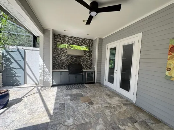 a view of a porch with furniture and a yard