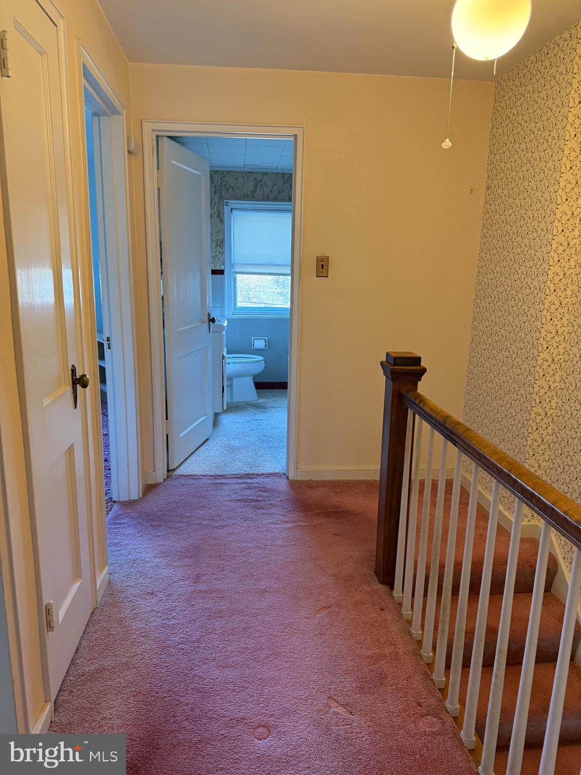 337 Linden Lane Reading, PA 19611 - Photo 7 of 14 a view of a hallway with wooden floor and a bathroom