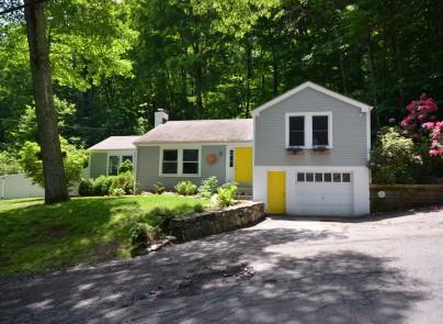 31 Wilridge Road Wilton, CT 06897 - Photo 1 of 1 a front view of a house with a yard and garage