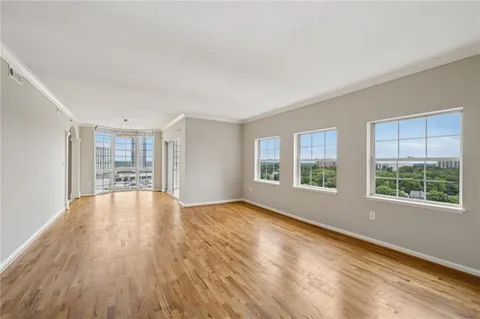a view of a room with wooden floor and outdoor space