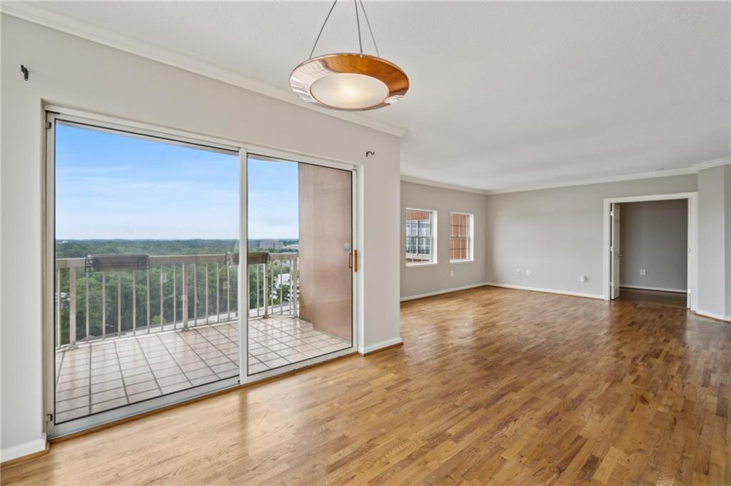 3435 Kingsboro Road Northeast, Unit 1702 Atlanta, GA 30326 - Photo 14 of 35 a view of empty room with wooden floor and floor to ceiling window