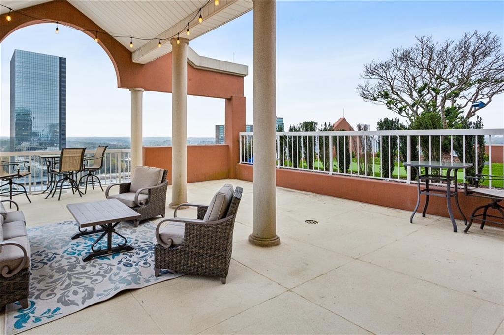3435 Kingsboro Road Northeast, Unit 1702 Atlanta, GA 30326 - Photo 26 of 35 a balcony with chairs and a potted plant